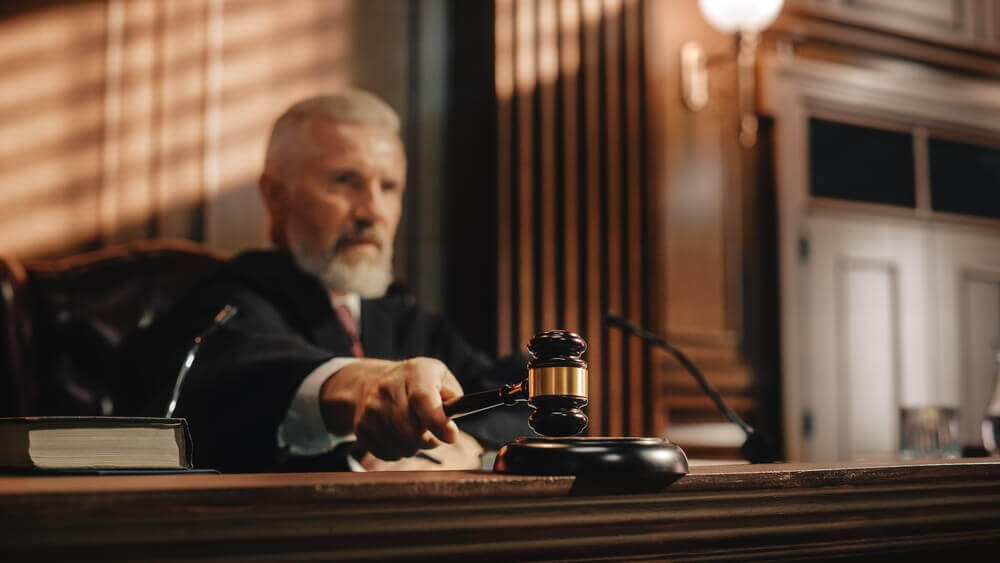 Court judge striking gavel for his verdict.
