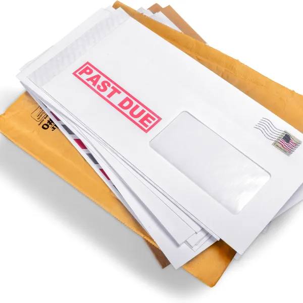 A photograph showing a stack of medical bills from a truck accident.