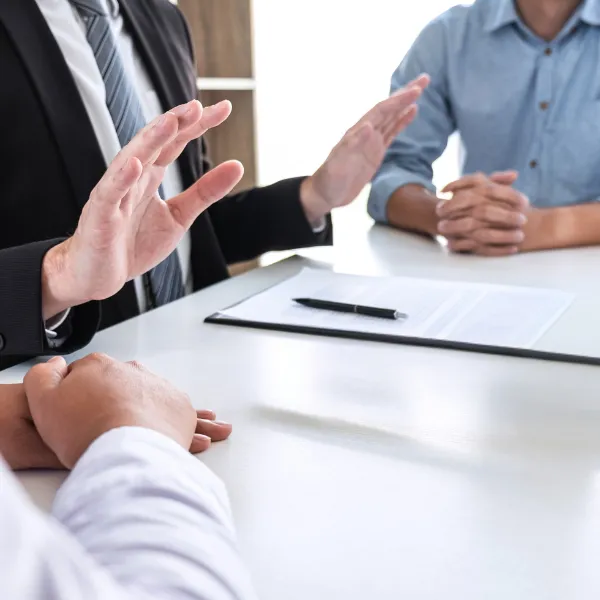 Image showing an attorney explaining legal options to clients.