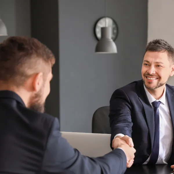 An image showing a person happy speaking with a lawyer. 