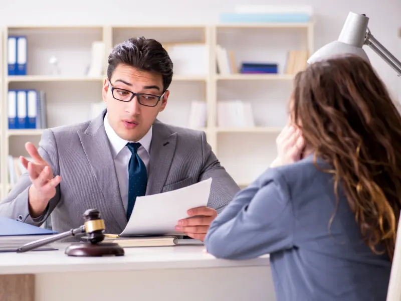 Image showing a person talking with a lawyer after being hit by a truck driver.